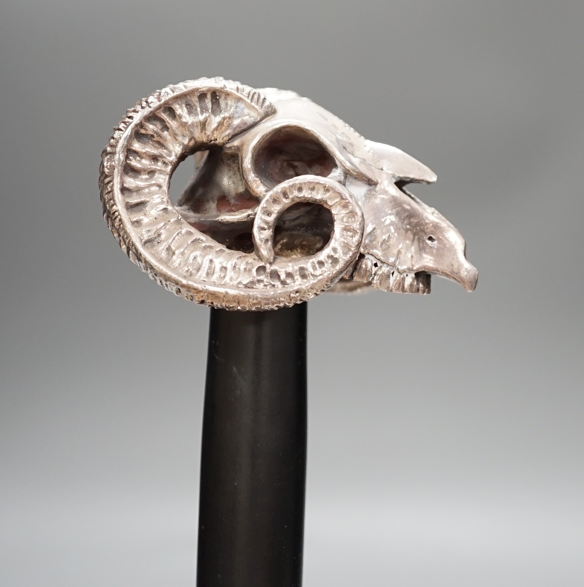 A Jeffery West umbrella with modern filled silver ram skull handle